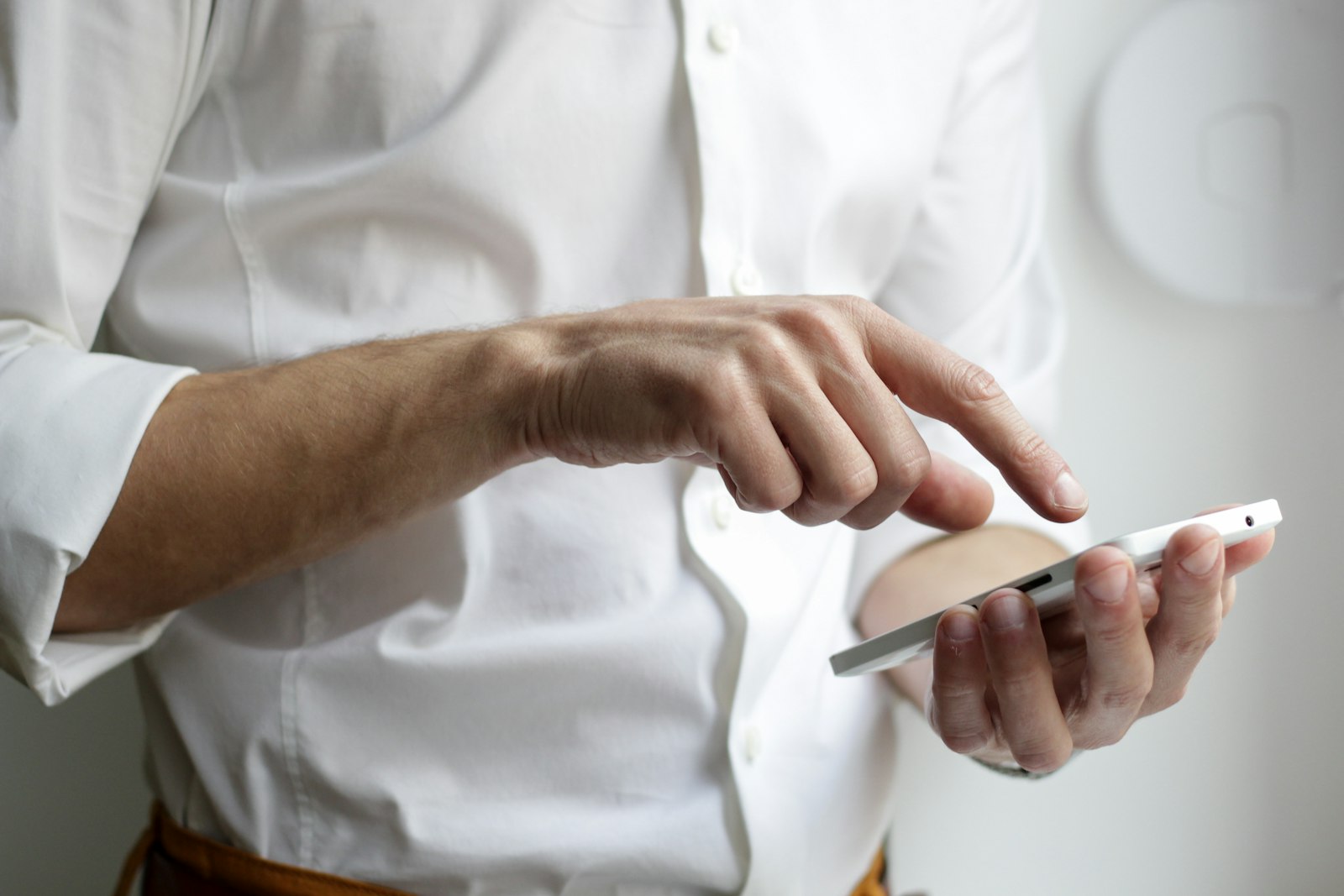 Hospitality worker on shift, mobile in hand