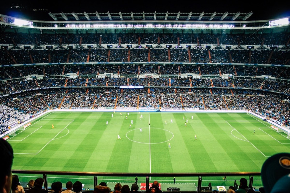 A packed stadium under floodlights