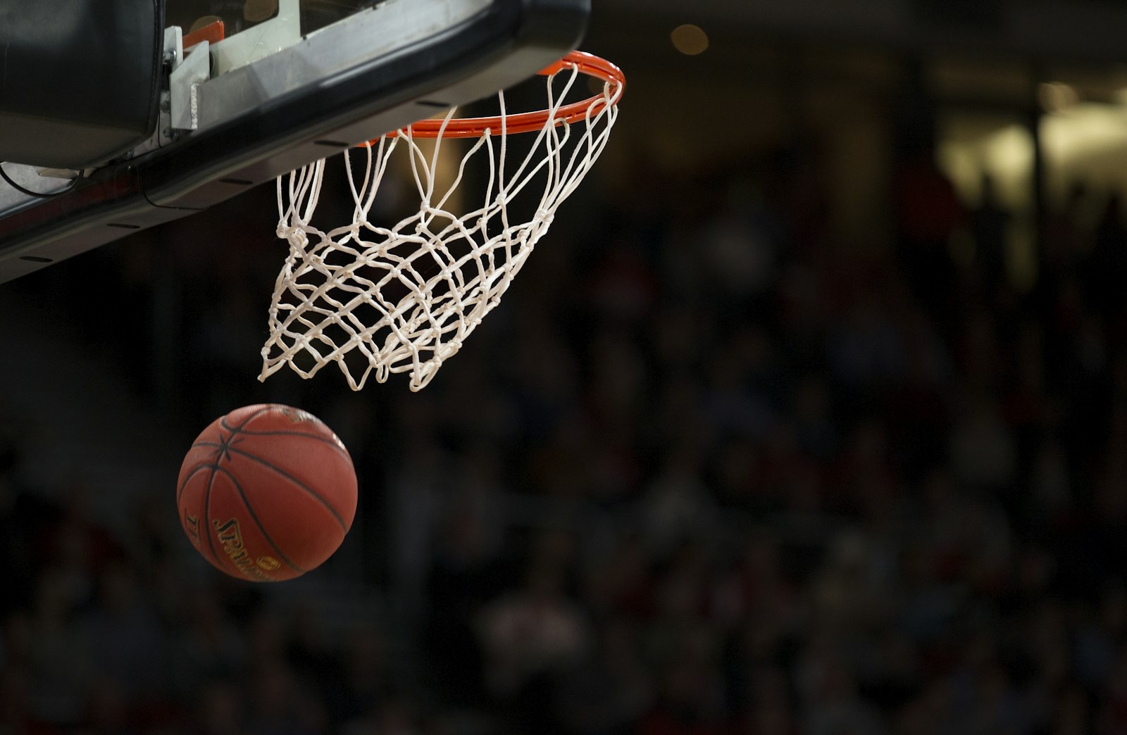 A basketball dropping through the net
