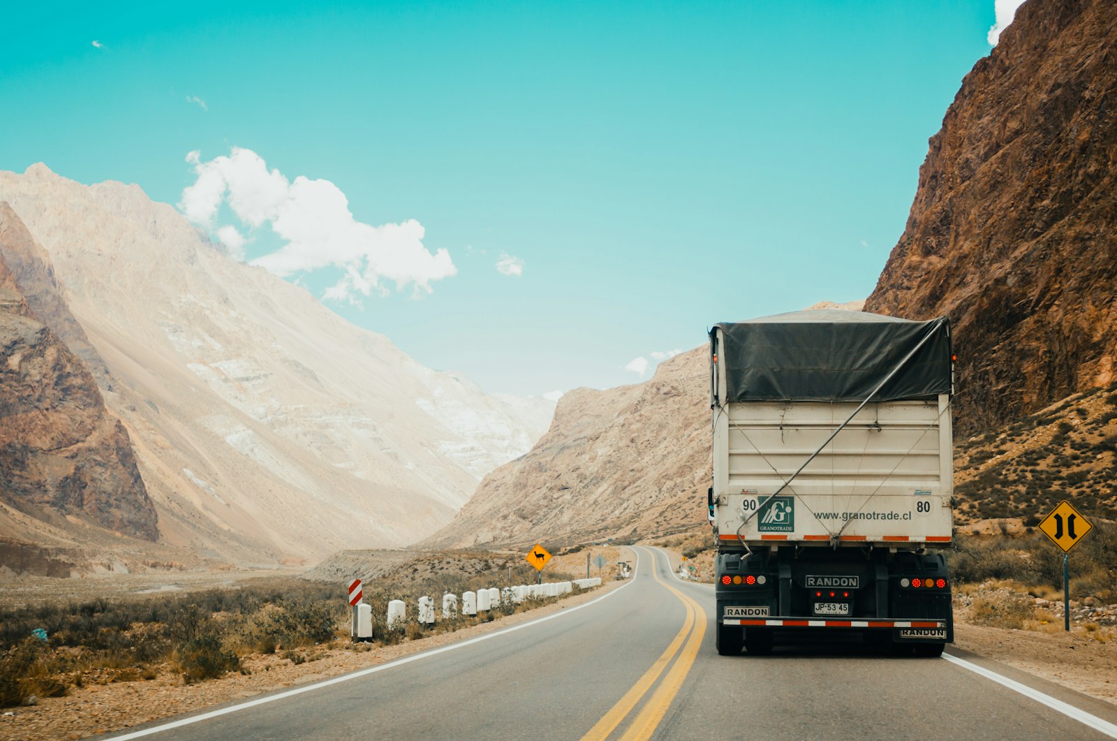 Semi-truck on an open highway at dusk — the transportation-industry buyer